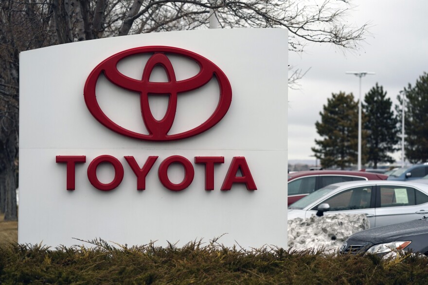 The Toyota logo adorns a sign outside a dealership