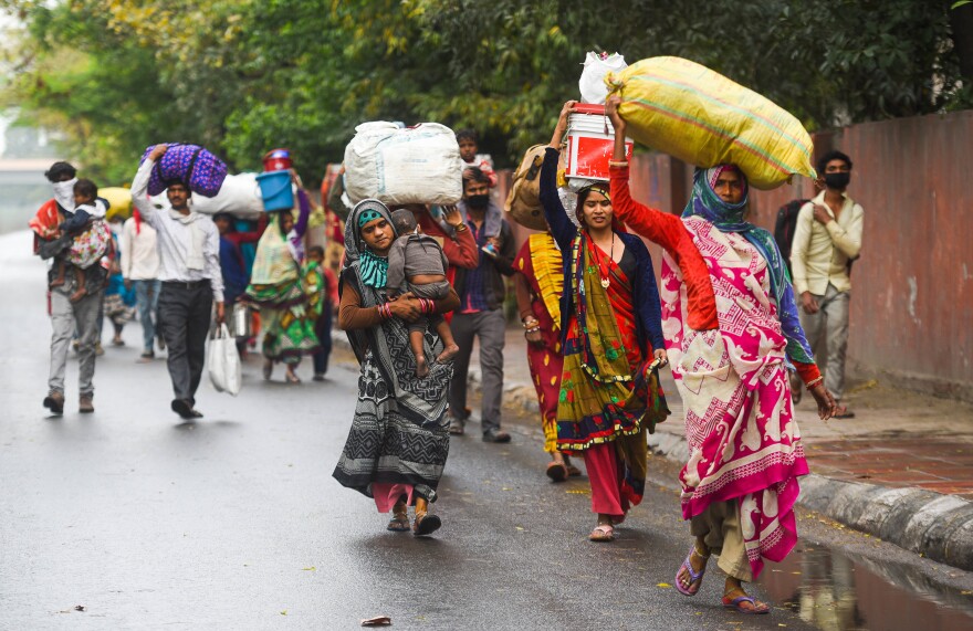 Migrant workers head home from New Delhi after the national lockdown took effect.