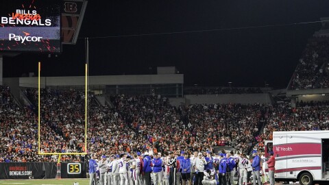 The Buffalo Bills players pray for teammate Damar Hamlin during the first half of an NFL football game against the Cincinnati Bengals, Monday, Jan. 2, 2023, in Cincinnati. The game has been postponed after Buffalo Bills' Damar Hamlin collapsed, NFL Commissioner Roger Goodell announced. (AP Photo/Joshua A. Bickel)