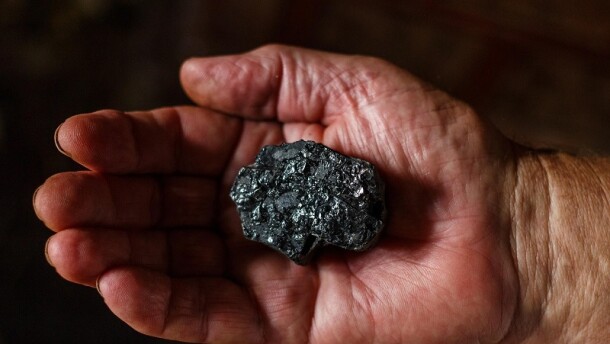 Stock photo of someone holding coal