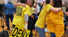 Members of the Archbald community hug each other after borough council denied a data center campus developer's zoning application.