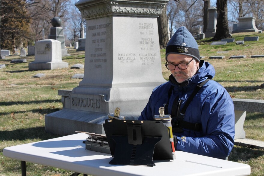 Artist Tim Youd retypes William Burroughs' "Naked Lunch" at the author's gravesite in St. Louis' Bellefontaine Cemetery in 2018.