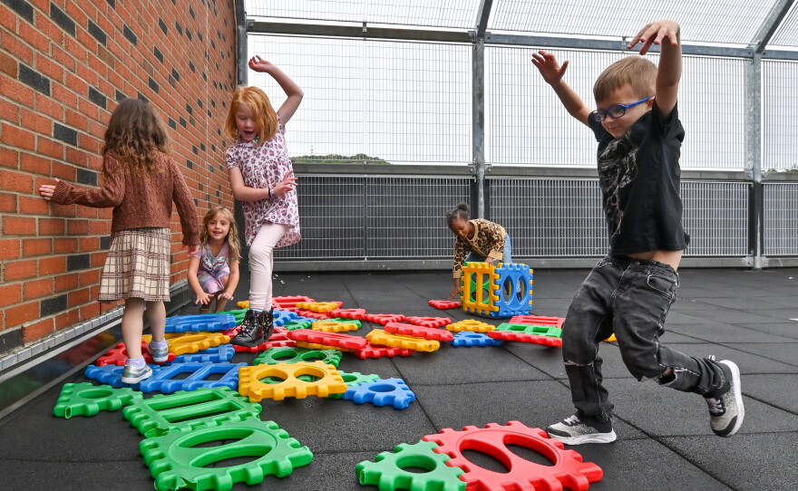 Kindergarten students in the Saint Clair Area School District play on the rooftop playground during recess.