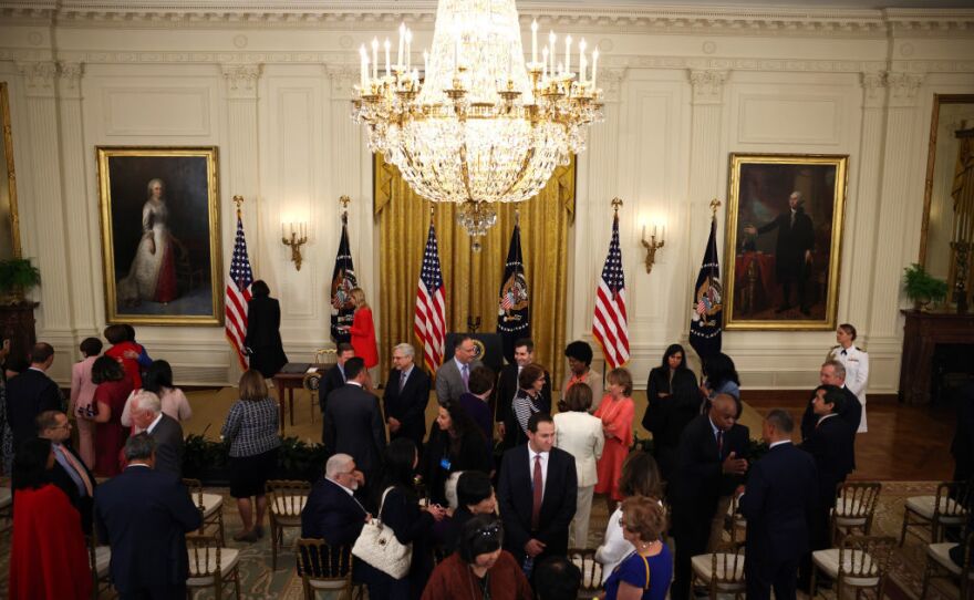 Guests mingle before President Biden arrives to a signing ceremony for the COVID-19 Hate Crimes Act in the East Room of the White House on Thursday.