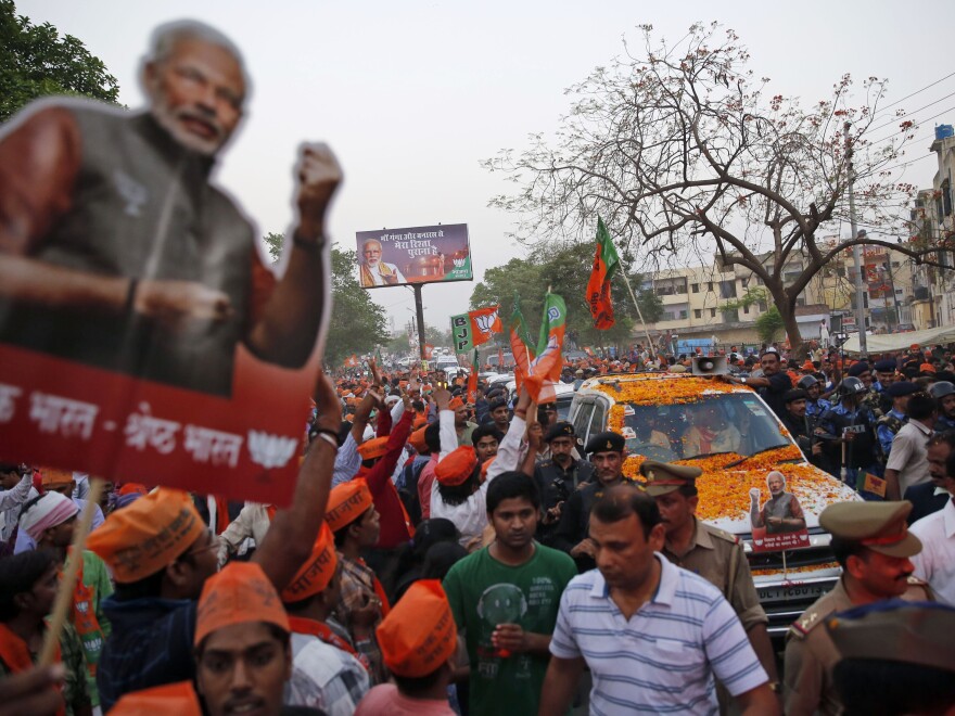 Supporters of Narendra Modi, the Hindu national leader running for prime minister, crowd his car as he travels to his party's election office in Varanasi.