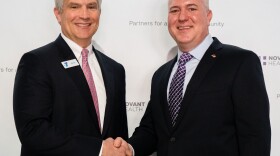 Darryl Head, president and CEO of the YMCA of Northwest North Carolina, shakes hands with Chad Setliff, senior vice president and president Novant Health Forsyth Medical Center and the greater Winston-Salem market, during an announcement of an expanded partnership between the two organizations. Image courtesy of Novant Health.