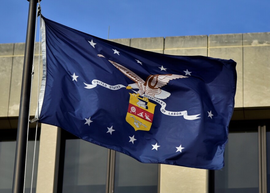 The Department of Labor seal on a flag flying outside the federal headquarters in Washington D.C.
