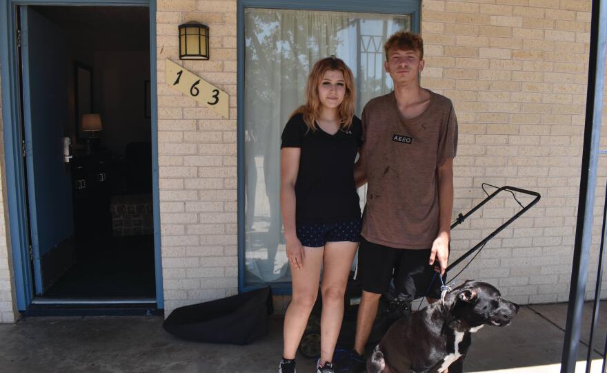 Anika Drew and Nicholas Stone pose with their dog, Chubz, outside their motel room on Friday, July 14, 2023, in Woodward, Oklahoma.