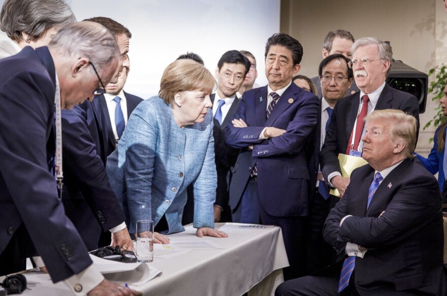 German Chancellor Angela Merkel, center, speaks with President Trump while surrounded by other world leaders during the G7 Leaders Summit in La Malbaie, Quebec, Canada in June.