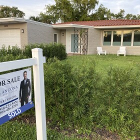 A home with a "Sold" sign is shown, Sunday, May 2, 2021, in Surfside. Home mortgage rates have risen to 20-year highs since then as the Federal Reserve has hike interest rates to fight inflation. (AP Photo/Wilfredo Lee)