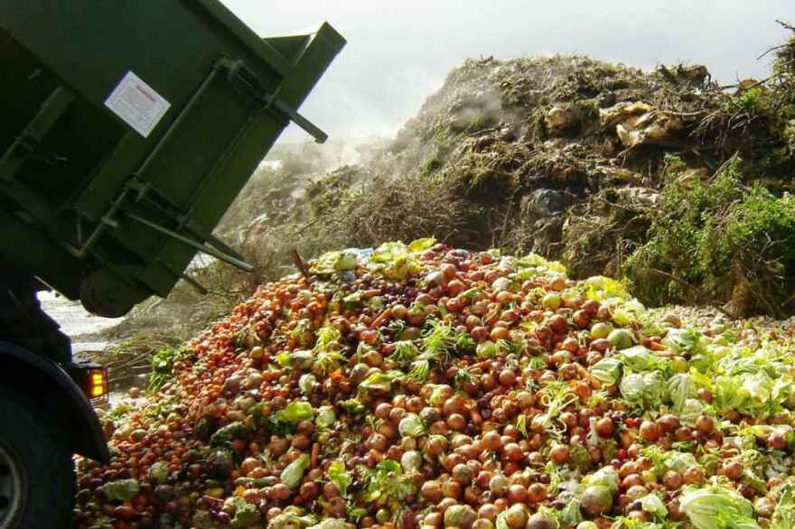 Frontloader dumping wasted produce.