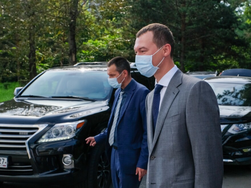 The acting governor of the Khabarovsk region, Mikhail Degtyaryov (right), visits a local hospital on Thursday. Russian President Vladimir Putin appointed him earlier this month. On his first night on the job, protesters chanted, "Degtyaryov, go away!"