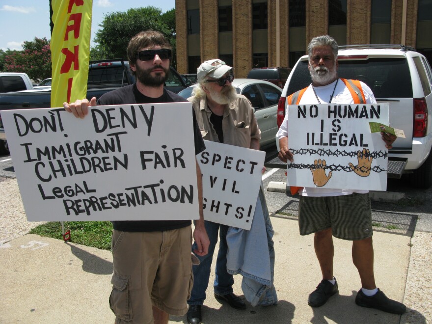 Protesters outside a San Antonio courthouse advocate for legal representation for immigrant children.