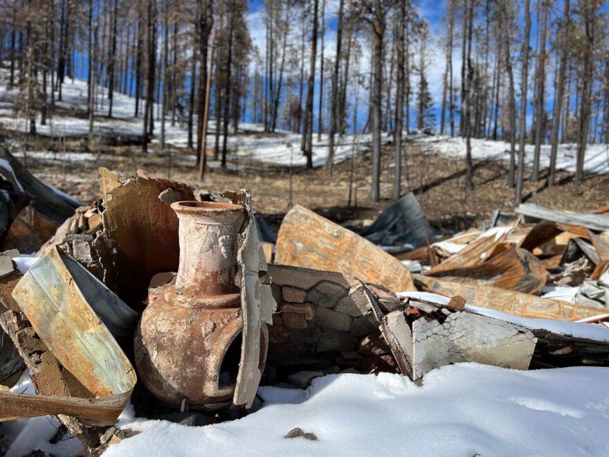A chimenea sits Feb. 8, 2023, amid the rubble of a cabin burned by the Hermits Peak-Calf Canyon fire in 2022. The state Insurance Superintendent is asking the Legislature to extend a $10 million fire mitigation program for homeowners in high-fire-risk areas. (Patrick Lohmann / Source New Mexico)