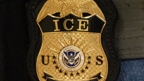 FILE - A federal agent wears an Immigration and Customs Enforcement badge in New York, June 10, 2025.