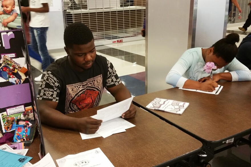 Derius Matthews, 17, fills out forms on registration day. He says he's ready for his senior year — and Thorton High's football season — to start.