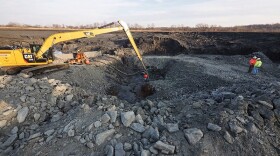 Workers excavate coal ash at the Dan River Power Plant in 2014, following a 39,000 ton spill of the substance into the Dan River.