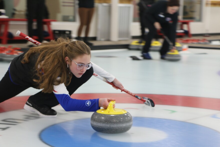 Hannah, a student at Traverse City Christian School, demonstrates the proper curling form. (Austin Rowlader, IPR News)