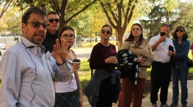 History professor Jay Price speaks to a group of students and staff as part of an on-campus, guided tour about the history of Wichita State. The tour was a one-time event, but a self-guided audio tour is available on WSU's website.