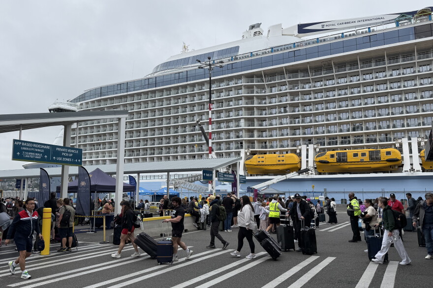 Cruise ship passengers walk with their luggage at the Port of Seattle's Smith Cove Cruise Terminal on Aug. 10, 2026.