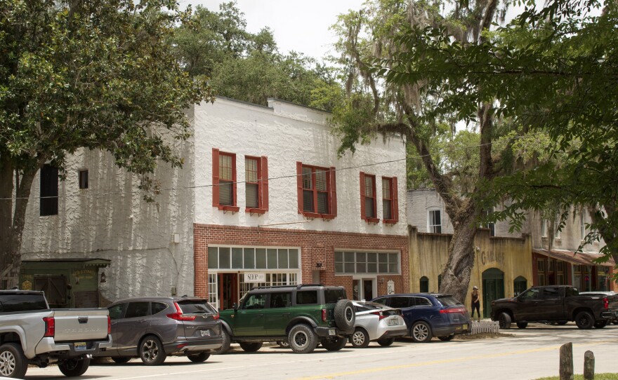 Vehicles line the historic main strip of Cholokka Boulevard; even on a Tuesday, Micanopy’s shops remain busy.