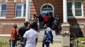 Asylum seekers, many from Angola and the Democratic Republic of the Congo, wait outside Sanford city hall on Monday, hoping to get an appointment with the General Assistance office. Dozens of new immigrants have arrived in Sanford in the last week, hoping to find assistance after shelters in larger cities, including Portland, have hit capacity.