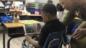 Five-year-old L.J. practices reading with a teacher at Infinity Generation Preparatory School.