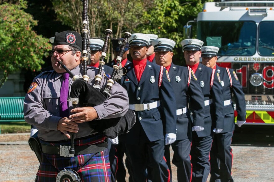Bagpiper marching with firefighters