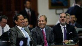 Texas Attorney General Ken Paxton, center, sits between defense attorneys Tony Buzbee, left, and Mitch Little, right, before starting the ninth day of his impeachment trial in the Senate Chamber at the Texas Capitol on Friday, Sept. 15, 2023, in Austin, Texas. &#13;
&#13;
 