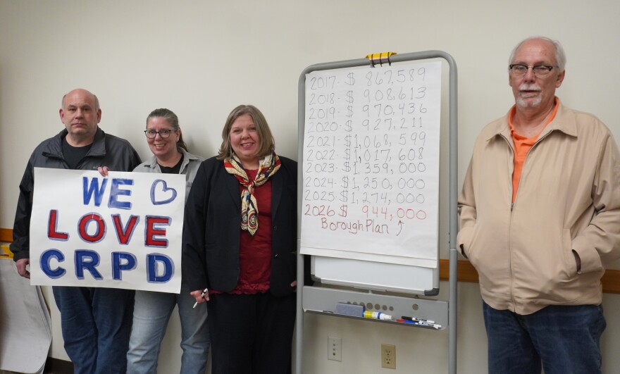 Several members of the "Save the CRPD" group pose next to a breakdown of Clearfield Borough's yearly spending on police services since 2017. From left to right is Joe Marino, Kelley Fulton, Christina Fulton and Bruce Fair. 