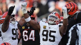 Cleveland Browns defensive end Myles Garrett (95) celebrates with defensive end Adin Huntington (98) after sacking Cincinnati Bengals quarterback Joe Burrow to set an NFL record for sacks in the regular season during the second half of an NFL football game, Sunday, Jan. 4, 2026, in Cincinnati.