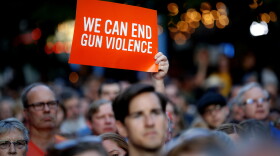 Mourners gather for a vigil at the scene of a mass shooting, Sunday, Aug. 4, 2019, in Dayton, Ohio. 
