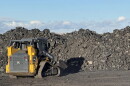 A row of coal next to skid steer inside the Navajo Transitional Energy Company coal yard in New Mexico.