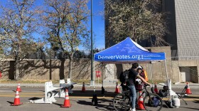  A voter drops off their ballot at an official dropbox on Bannock St. in Denver on Friday, November 3, 2023. This particular dropbox is designed for people who are biking or driving. Ballots must be submitted by the time the polls close at 7:00 p.m. Tuesday.
