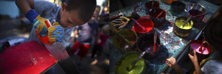 Tyler Swenson, 7, saws a board that he has already painted bright red.
