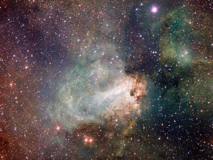 The star-forming area Messier 17, also known as the Omega Nebula or the Swan Nebula, is a vast region of gas, dust and hot young stars that lies in the heart of the Milky Way in the constellation of Sagittarius.