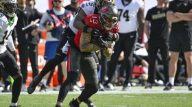 wide receiver getting tackled after catching the ball