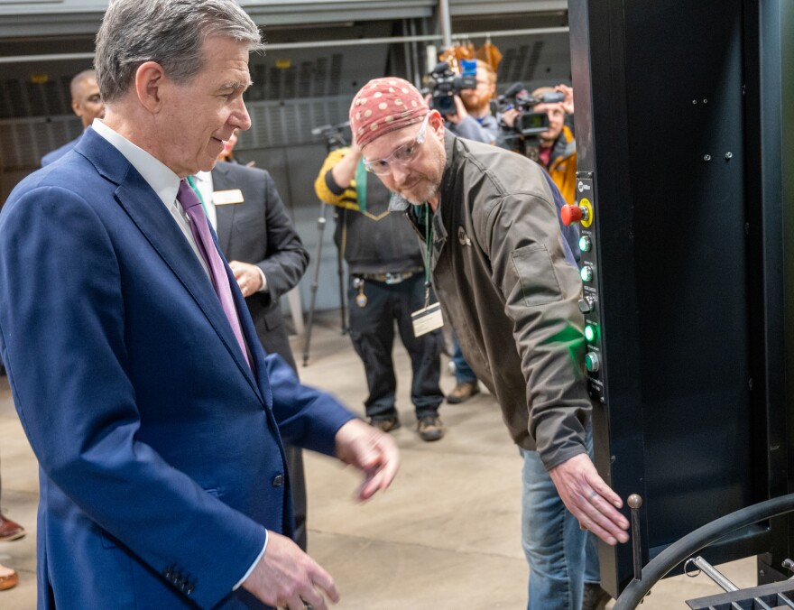 Gov. Roy Cooper gets a brief tour from GTCC welding instructor Zeb Downey at the school’s Center for Advance Manufacturing. Photograph by Tu Nguyen.