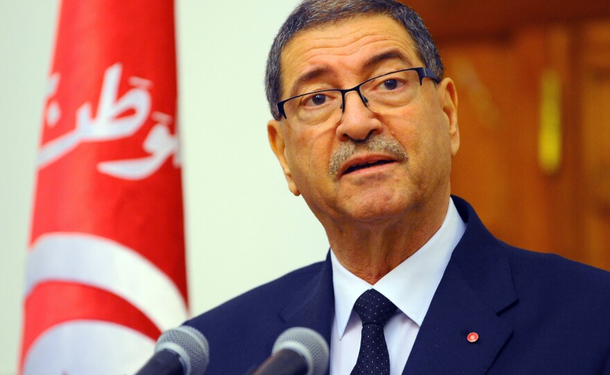 Tunisian Prime Minister Habid Essid addresses the media in the capital, Tunis, on March 8. He spoke a day after clashes between government forces and extremists in southern Tunisia, near the Libyan border, which left more than 50 dead.