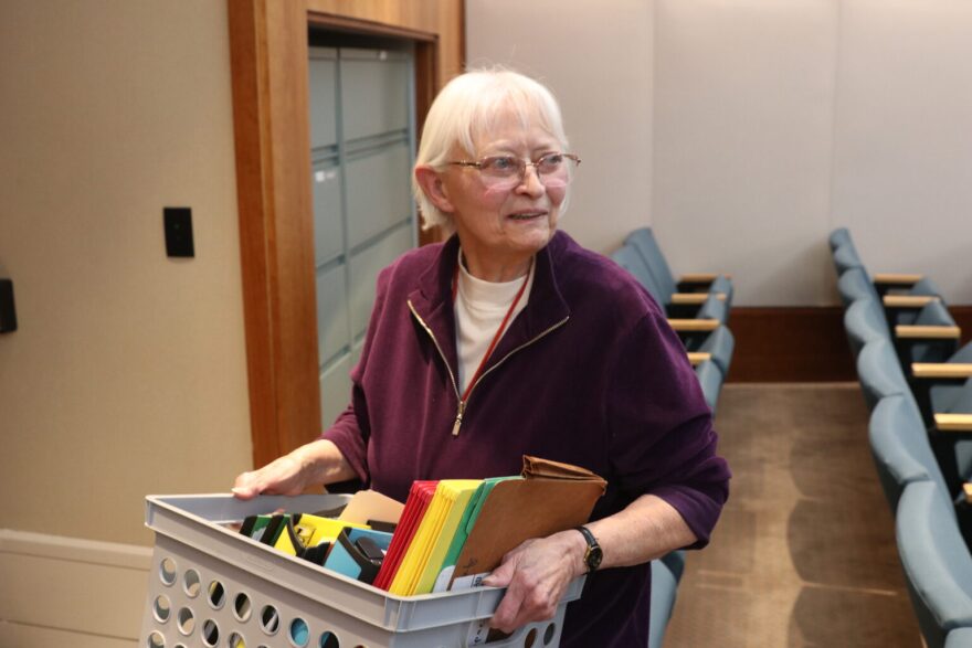 Rep. Marian Matthews (D-Albuquerque) carries a box of health care compact materials out of a House committee room Jan. 26, 2026. (Danielle Prokop/Source NM)