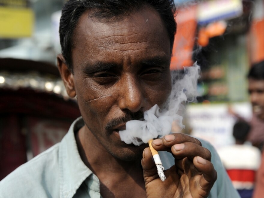 A man exhales smoke in Dhaka, Bangladesh. The latest World Health Organization-Bangladesh government survey has found 43.3 per cent of the country's adult population now use tobacco, up from 37 percent in 2004.
