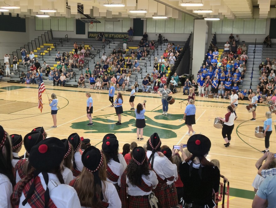 Current Central High Kilties look on from the stands of the Parkview gym as an alumni team of Glendale Scotties performs.