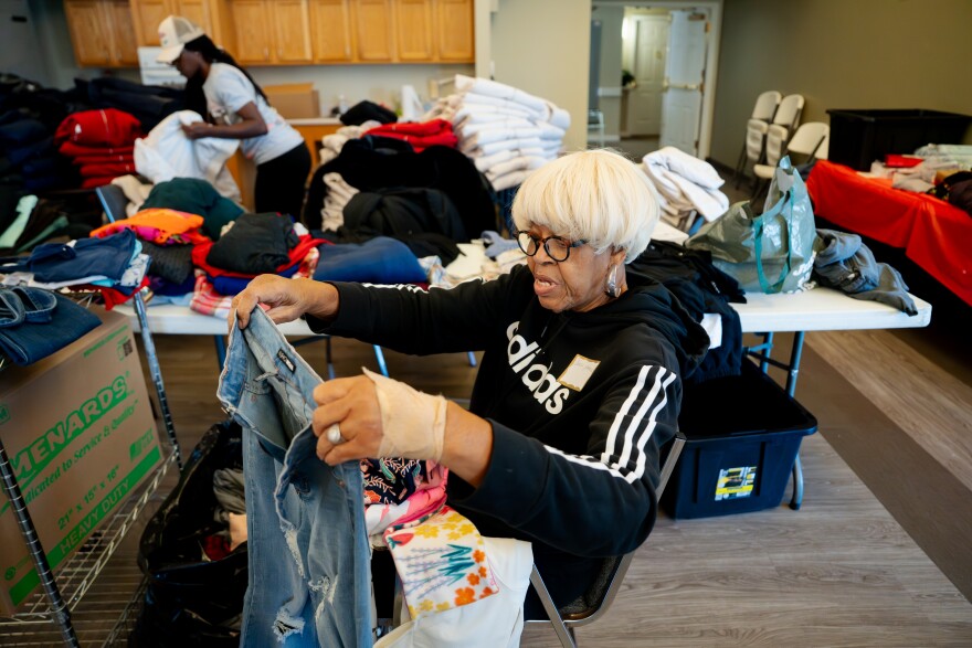Doris Patrick, an UnGUN Institute volunteer from Cool Valley, sorts through dozens of boxes of clothes to be donated to the community on Tuesday, Nov. 4, 2025, at the organization’s office on Tuesday, Nov. 4, 2025, in St. Louis’ Hamilton Heights neighborhood.