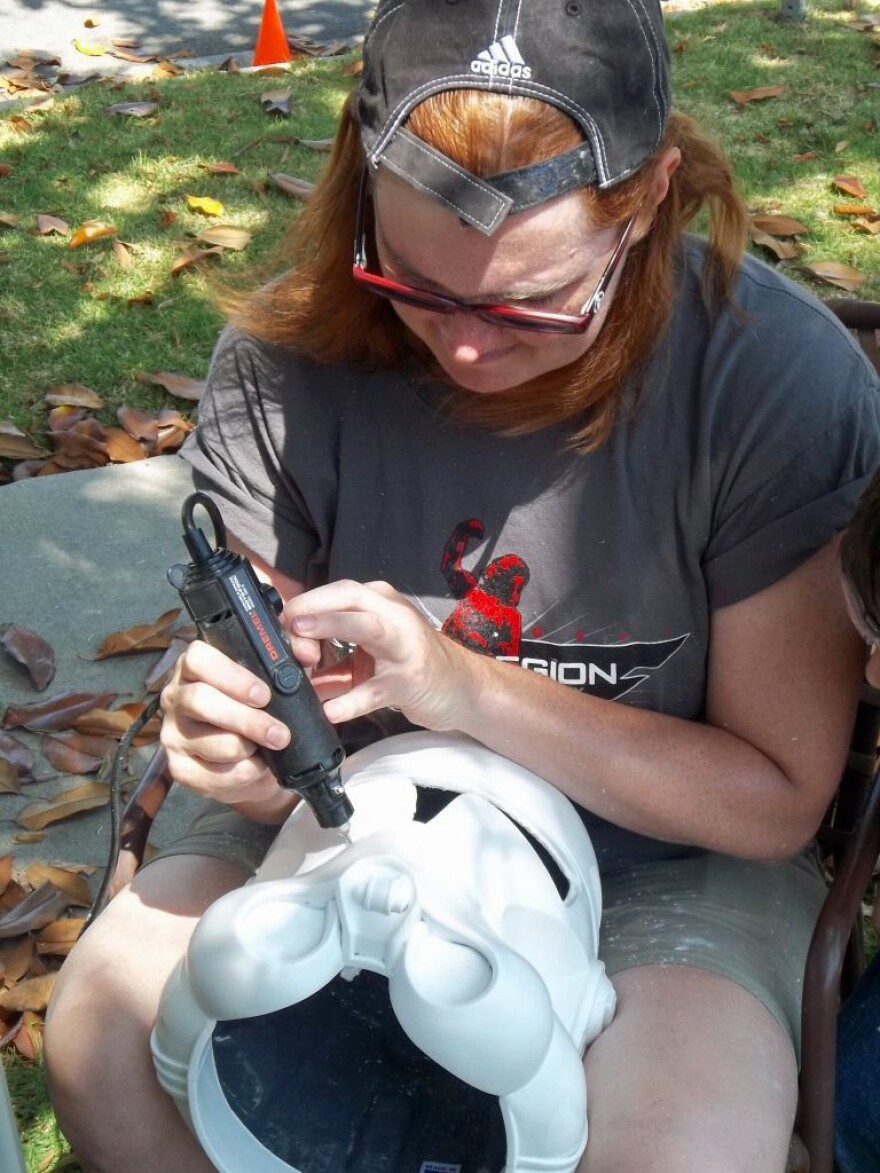 Garrison member Ingrid Moon works on a Clone Trooper helmet at an armor party. Moon is also executive officer of the First Imperial Stormtrooper Detachment.