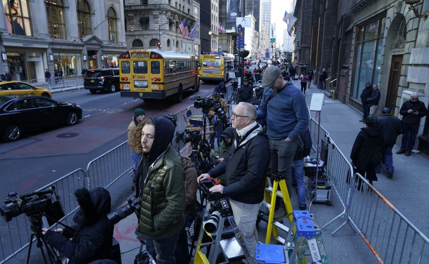 Members of the media wait outside the Manhattan District Attorney's office in New York City on Monday.