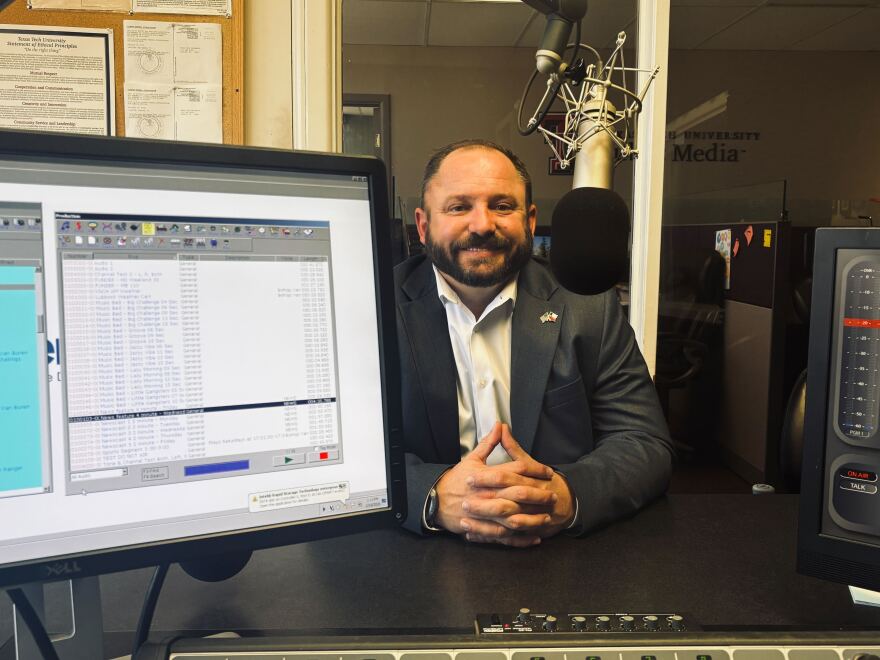 A photo of Jason Corley sitting in the KTTZ studio.