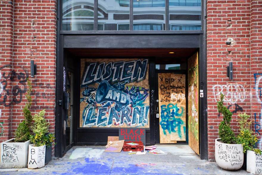 Artwork covers the boarded up windows of the Seattle Police Department's East Precinct.