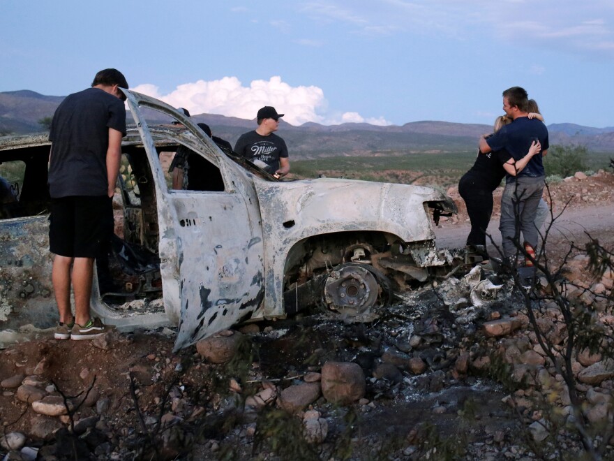 Relatives of slain members of Mexican American families belonging to Mormon communities visit the burned wreckage of a Chevrolet Tahoe where five of their relatives died in northern Mexico.