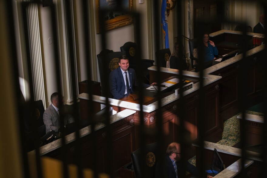 House Speaker-elect Kyle Hilbert, R-Bristow, sits at the head of the House of Representatives chamber and smiles at a fellow lawmaker during the House’s swearing-in ceremony, Nov. 20, 2024, at the Oklahoma State Capitol. Hilbert is the youngest representative to serve in the Oklahoma House’s top leadership position in state history.