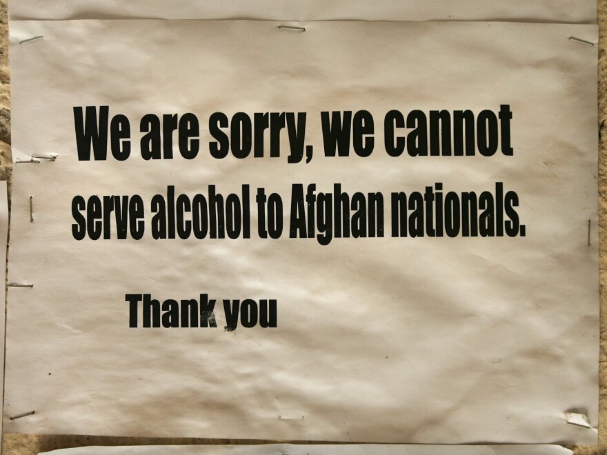 A sign posted at the entrance of a French restaurant in Kabul (from February 2006) highlights one of the many vagaries of rules governing alcohol in Afghanistan and elsewhere in the Muslim world.